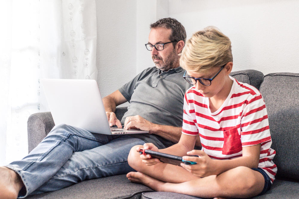Family devices on a kitchen table: a family tech agreement for two homes